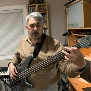 Bass player focusing on unique music